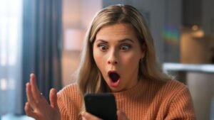 shocked-woman-face-phone-scam-926425296.jpg