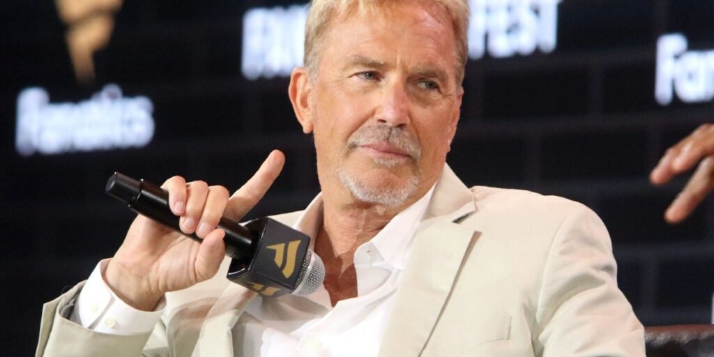 kevin-costner-holding-a-microphone.jpg