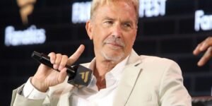 kevin-costner-holding-a-microphone.jpg