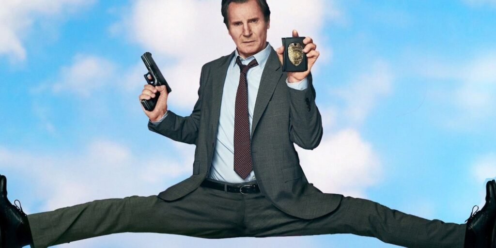 liam-neeson-in-a-deep-split-holding-a-gun-and-a-badge-in-the-new-naked-gun.jpg