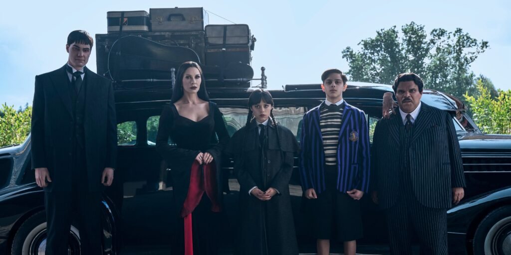 lurch-morticia-wednesday-pugsley-and-gomez-addams-standing-in-front-of-their-car-in-wednesday-season.jpeg